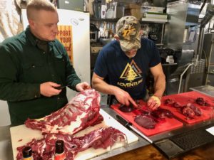 Teaching a student how to butcher a deer