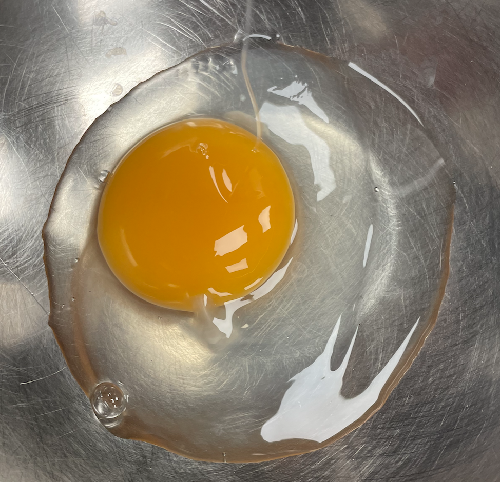 cracked egg with yellow yolk